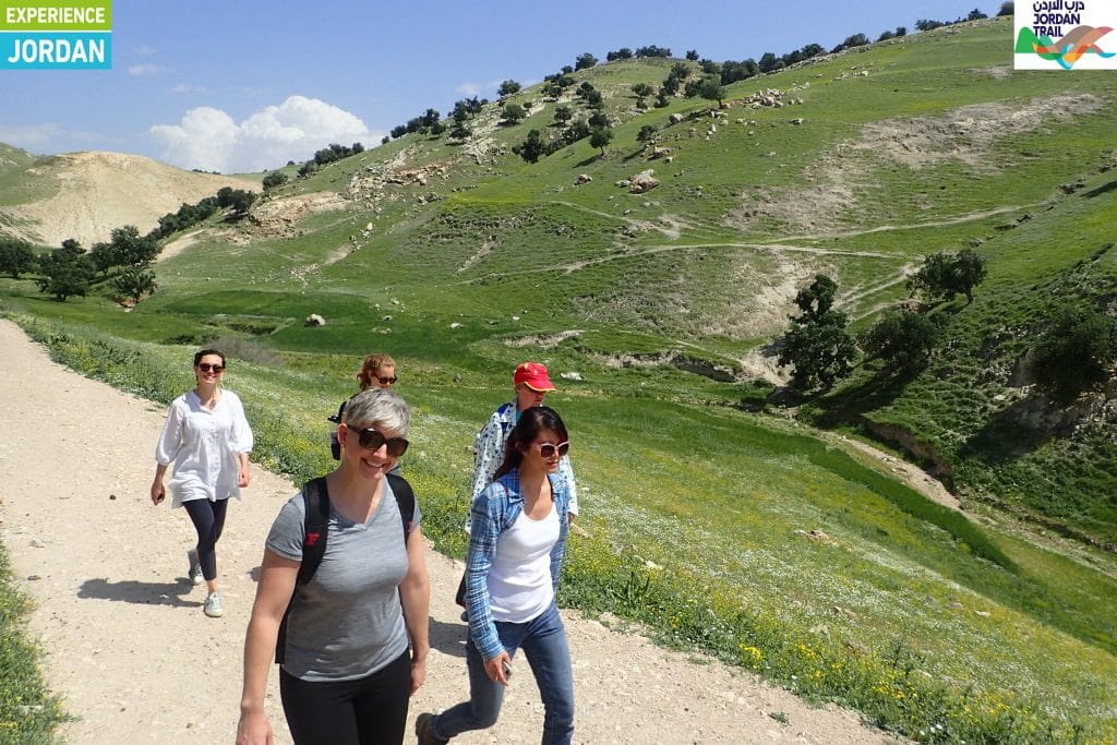 Hikers in the green hills of northern Jordan in spring
