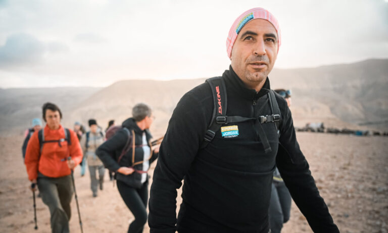 Experience Jordan Adventures local guide leading a hiking group in Jordan